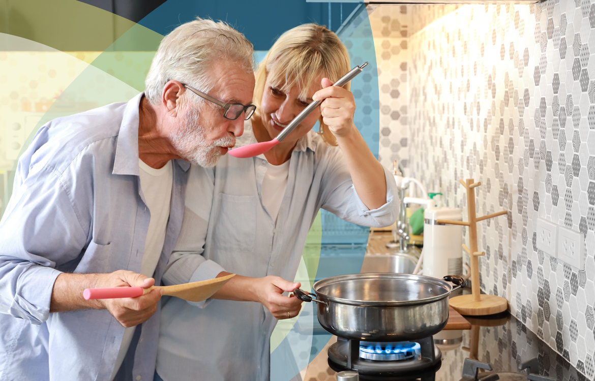 Älteres Pärchen beim Kochen mit Gas in Böblingen, hinter ihnen bunte SWBB Sphären