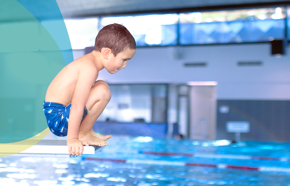 Junge auf dem Sprungbrett im Hallenbad in Böblingen, hinter ihm bunte SWBB Sphären